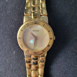 Gucci watch with mother of pearl face